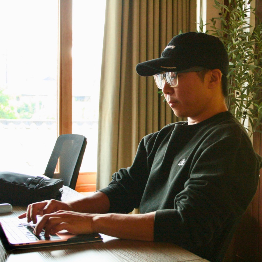 Jason Tang at work on his laptop